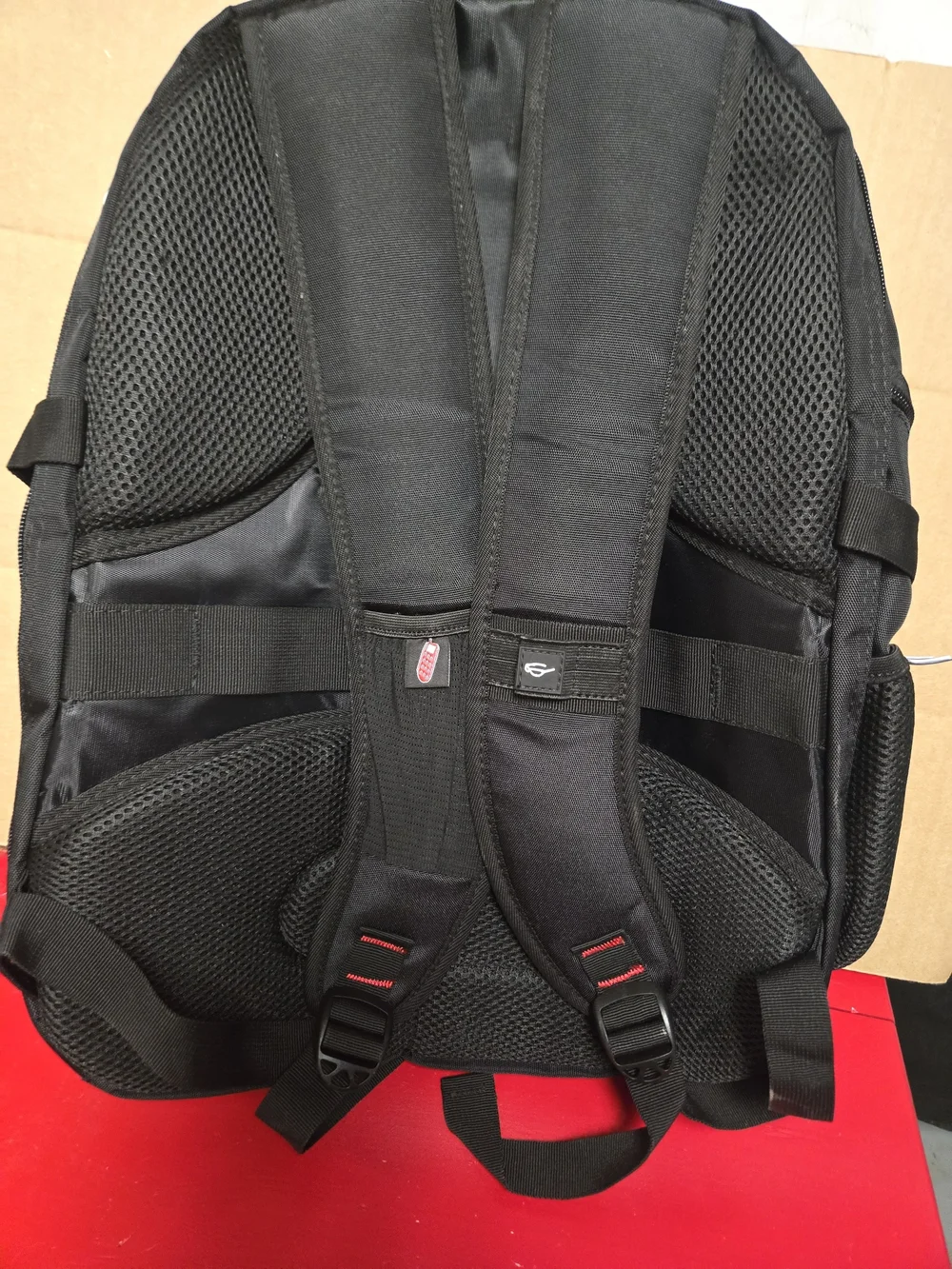 SHRRADOO travel backpack features vibrant red accents on the zippers and strap.